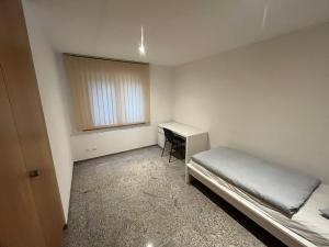 a small room with a bed and a desk at Château Schnidrig in Stalden +9 photos
