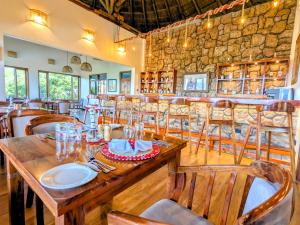 a dining room with a wooden table and chairs at Maasai ecoLodge in Karatu