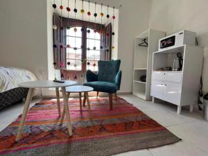 a living room with a table and a chair at Darios Hotel in Cusco