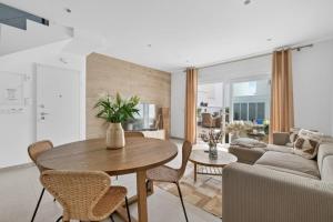 a living room with a table and a couch at Modern new Pool Villa in San Pedro del Pinatar