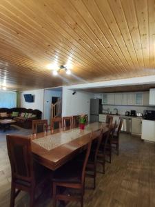 a dining room with a large wooden table and chairs at Casa Iulia & Matei in Cârțișoara
