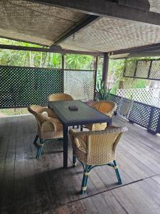 a wooden table and chairs on a deck at Chalet Avea in Parea