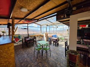 a restaurant with tables and chairs and a large window at Darios Hotel in Cusco
