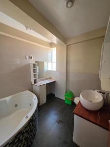 a bathroom with a large tub and a sink at Darios Hotel in Cusco +16 photos