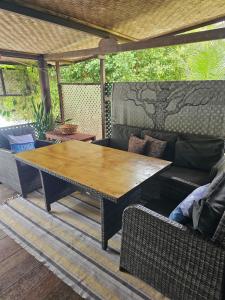 a wooden table and couch on a patio at Chalet Avea in Parea +6 photos