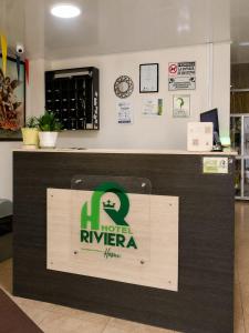 a sign for a new rivieraarmaarmaarmaarmaarmaarmaarmaarma at Hotel Riviera Home in Pasto