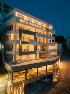a hotel with lights on the side of a building at Hotel Mediterraneo Liman in Ulcinj