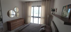 a bedroom with a bed and a window and mirrors at Magnolia Rooms - Val Di Chy in Val di Chy