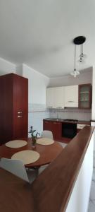 a kitchen with tables and chairs in a kitchen at Magnolia Rooms - Val Di Chy in Val di Chy