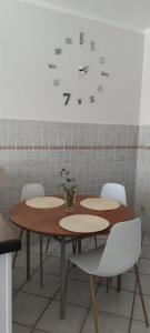 a room with tables and chairs and a clock on the wall at Magnolia Rooms - Val Di Chy in Val di Chy