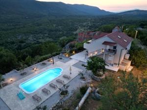 an aerial view of a house with a swimming pool at Villa Brig in Ramljane