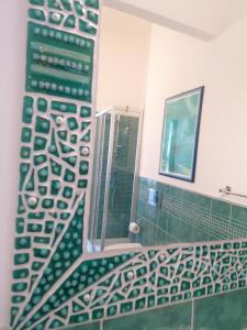 a bathroom with a shower and a mirror at Casa Mosaico in Volterra +16 photos