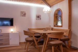 a dining room with a wooden table and chairs at Chalet Heimetli in Grächen