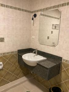 a bathroom with a sink and a mirror at Tuek Khiaw Samui Hotel in Bophut