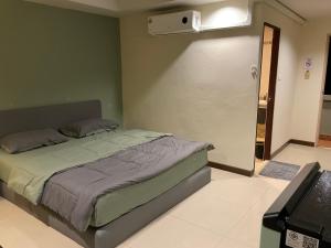a bedroom with a bed and a wall with a projector at Tuek Khiaw Samui Hotel in Bophut