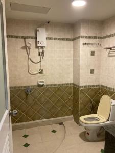 a bathroom with a shower and a toilet at Tuek Khiaw Samui Hotel in Bophut
