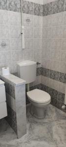 a bathroom with a toilet and a sink at Magnolia Rooms - Val Di Chy in Val di Chy +1 photo