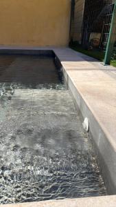 a pool of water on the side of a sidewalk at Casa Serrano in Abrucena
