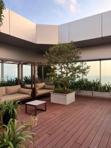 a patio with couches and a table on a building at The Signature Suites at Cinnamon life Apartment in Colombo