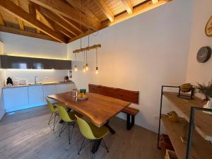 a kitchen and dining room with a wooden table and chairs at Casa Tritão - Gerês in Campo do Gerês