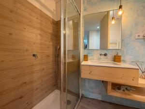 a bathroom with a shower and a sink and a mirror at Casa Tritão - Gerês in Campo do Gerês +33 photos
