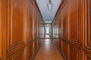 a hallway with wood paneled walls and a hallwayngth at MInerva Pantheon Suites in Rome