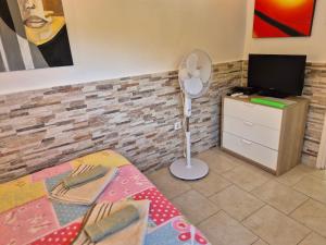 a room with a bedroom with a bed and a tv at Studio for short stay in Rabac