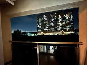 a view of a city at night from a window at Zen LuxStudio in Pune
