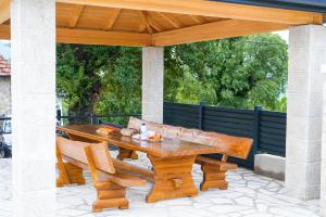 a wooden table and chairs on a patio at Villa Dub in Stolac