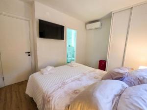 a bedroom with a bed and a flat screen tv at Villa Dub in Stolac