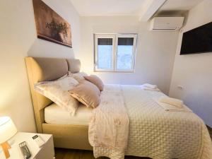 a bedroom with a bed and a window at Villa Dub in Stolac