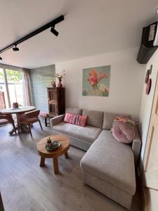 a living room with a couch and a table at Bed & Breakfast Betuws Genieten in Tiel