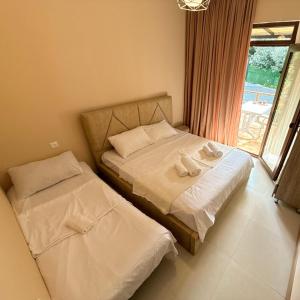 a bedroom with two beds and a window at Tsikhisdziri Panorama Cottage in Kobuleti