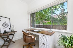 a home office with a desk and a window at Stylish Apartment, Malvern East in Melbourne