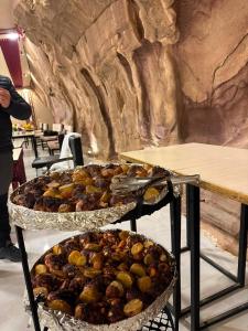two trays of food on display in a restaurant at Rum Red Sand Luxury Camp & Jeep Tours in Wadi Rum