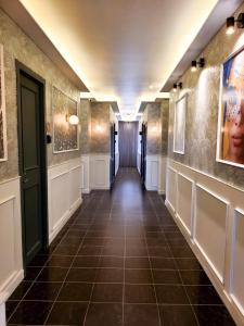 a hallway with a tile floor and a hallway with a door at Barrio Inn Padre Mier Hostal & Suites in Monterrey