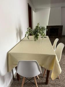 a table with a white table cloth and a plant on it at Alvarado in San Pedro