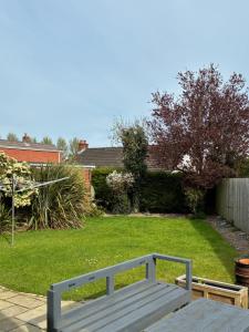 a wooden bench sitting in the middle of a yard at Loughshore, Large Detached House, Jordanstown in Newtownabbey