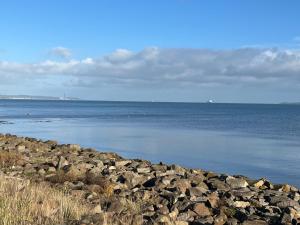 a large group of rocks on the shore of a body of water at Loughshore, Large Detached House, Jordanstown in Newtownabbey +8 photos