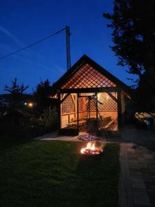 a gazebo in a yard at night at Domek Rosa in Bachlowa
