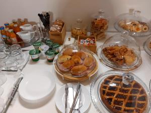 a table topped with plates and bowls of food at Bed and Breakfast Aida in Cotignola +16 photos