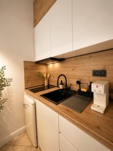 a kitchen with a sink and a counter top at Noema Park View in Xanthi