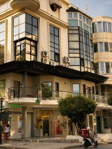 a man riding a scooter in front of a building at Noema Park View in Xanthi