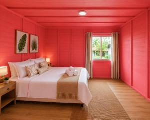 a red bedroom with a bed and a window at Cascata- Pousada Encanto Do Mar in Santa Irene