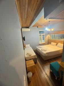a bedroom with two beds and a wooden ceiling at Hotel Megaron in Istanbul