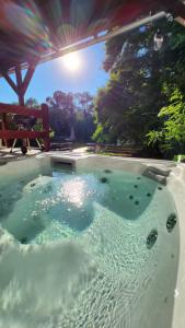 a hot tub in the middle of a patio at Ciprus Lak in Szarvas
