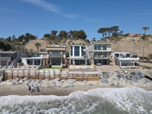 a house on the beach with a flock of birds at OCEAN FRONT - STUNNING VIEWS- VACATION PARADISE!! in Dana Point