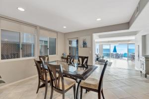 a dining room with a glass table and chairs at OCEAN FRONT - STUNNING VIEWS- VACATION PARADISE!! in Dana Point