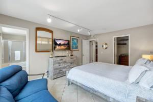 a bedroom with a bed and a tv and a couch at OCEAN FRONT - STUNNING VIEWS- VACATION PARADISE!! in Dana Point
