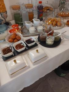 a table topped with plates and bowls of food at Bed and Breakfast Aida in Cotignola